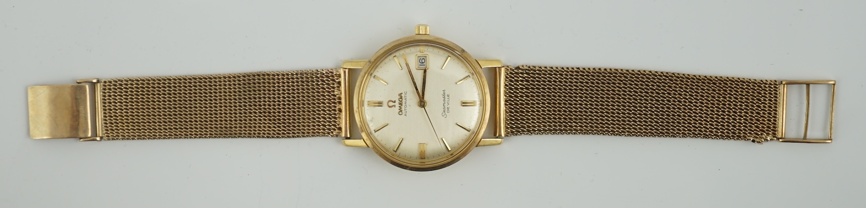 A gentleman's 1960's 18ct gold Omega Seamaster DeVille automatic wrist watch, on an associated 9ct gold bracelet